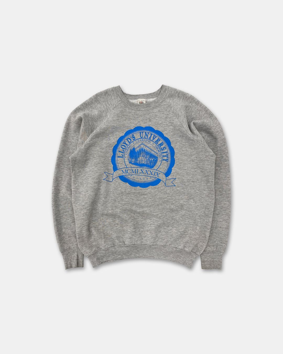 Vintage 1990s Lloyd's University Raglan Crewneck Heathergrey by Vintage in size XL from KNITWEAR category